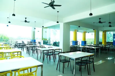 an empty restaurant with tables and chairs at Marina Heights Resort in Lumut