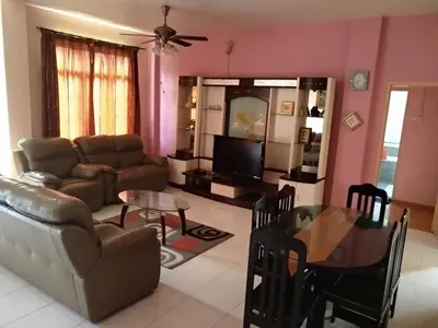 a living room with a couch and a table at Tenggafriz holidays in Cameron Highlands