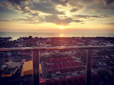 a view of a city with the sunset in the background at Sekinchan SeaView Homestay 134 \u9ad8\u697c\u770b\u6d77\u9633\u53f0\u6c11\u5bbf in Sekincan