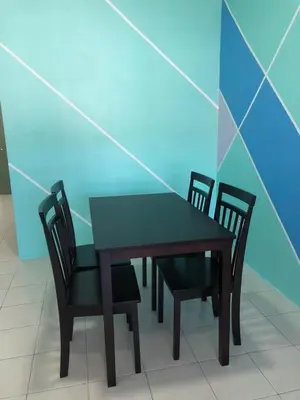 a table with four chairs and a table and a table and chairs at CH Homestay in Cameron Highlands