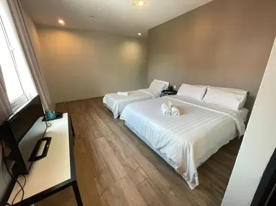 two beds in a hotel room with white sheets at Chariton Hotel Butterworth in Butterworth