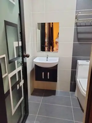 a bathroom with a sink and a toilet at Weng Kong Hotel in Slim River