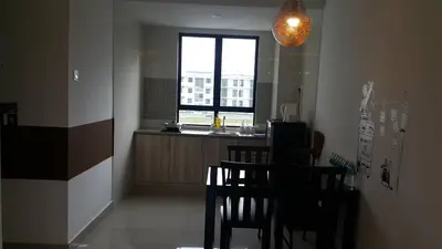 a dining room with a table and chairs and a window at The Meadow Park in Kampar