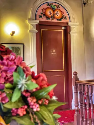 a bunch of flowers in front of a door at Nam Keng Hotel Penang in George Town