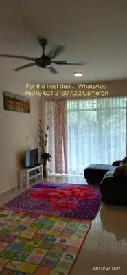 a living room with a rug on the floor at Azizi&Yati Muslim Homestay Cameron Highlands in Cameron Highlands