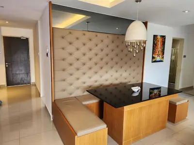 a dining room with a table and a bench at Peony Square Residences in Cameron Highlands
