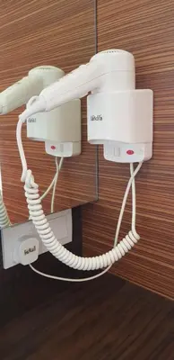 a white phone is hanging on a wall at Peony Square Residences in Cameron Highlands