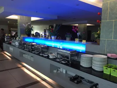 a restaurant counter with blue lighting in a restaurant at Grand Court Hotel in Teluk Intan