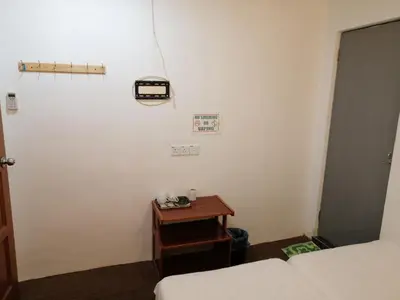 a small room with a bed and a table at StarVilla Kinta River Front Medan Istana in Ipoh