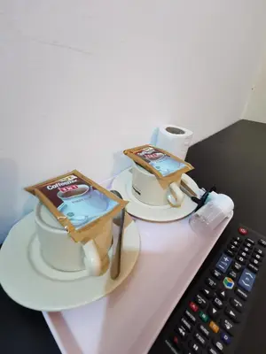 two cakes sitting on a table next to a remote control at StarVilla Kinta River Front Medan Istana in Ipoh