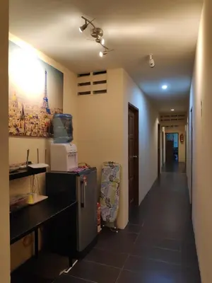 a room with a kitchen with a refrigerator and a hallway at StarVilla Kinta River Front Medan Istana in Ipoh