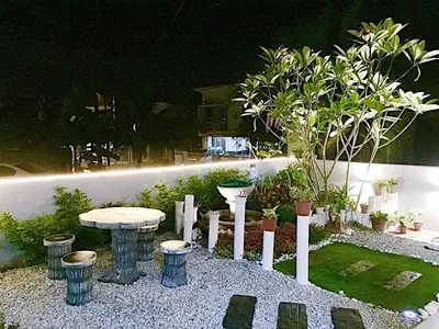 a garden at night with a table and some plants at Leisure Homestay in Kampong Peruntun