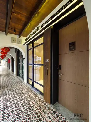 a hallway with a door and a tile floor at Hutton Central Hotel Managed by The Ascott Limited in George Town