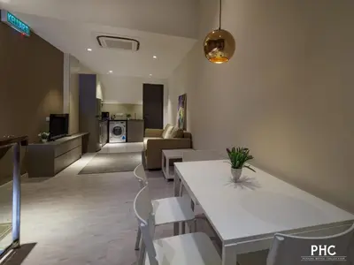 a living room with a white table and chairs at Hutton Central Hotel Managed by The Ascott Limited in George Town