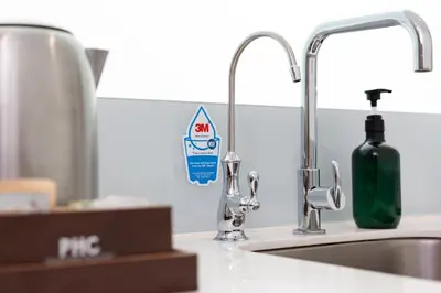 a kitchen sink with a bottle of soap next to it at Hutton Central Hotel Managed by The Ascott Limited in George Town