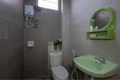 a bathroom with a toilet and a green sink at •Lovely Home•11Pax+4Bedrooms+Themed•Bukit Mertajam in Bukit Mertajam