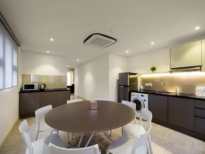 a kitchen and dining room with a table and chairs at Magazine Vista Hotel Managed by The Ascott Limited in George Town