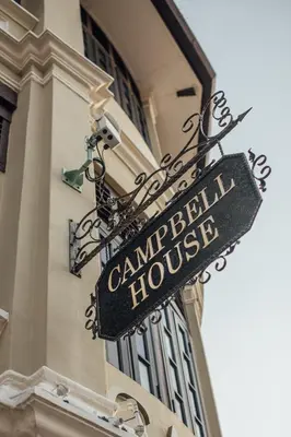 a street sign on the side of a building at Campbell House in George Town