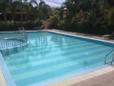 a large swimming pool with blue water at Pangkor Bay View Beach Resort in Pangkor