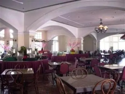 a dining room with tables and chairs in a restaurant at The Orient Star Resort Lumut in Lumut