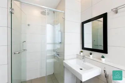 a white bathroom with a sink and a mirror at JOMSTAY Octagon Ipoh Suites in Ipoh