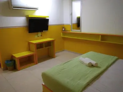 a room with a bed with a tv and a bed sidx sidx sidx at Hotel Abby IGB Tasek in Ipoh