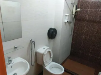 a bathroom with a toilet and a sink and a shower at Hotel Abby IGB Tasek in Ipoh