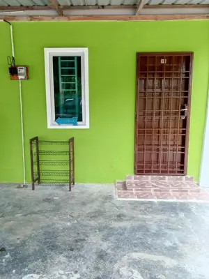 a green house with a window and a door at Panorama Homestay in Jeram