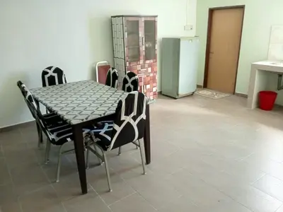 a dining room with a table and chairs at Panorama Homestay in Jeram