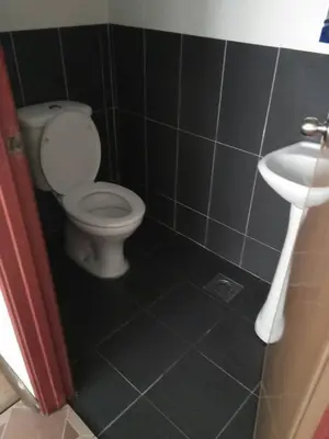 a bathroom with a toilet and a sink at Hotel Sri Malim Sungkai in Sungkai