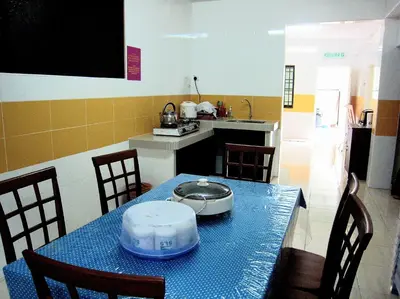 a kitchen with a table with a pot on it at Sakura Guest House in Cameron Highlands