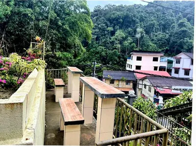 a balcony with benches and a view of a city at Sakura Guest House in Cameron Highlands