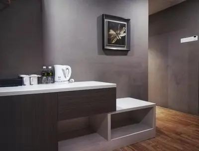 a kitchen with a counter and a picture on the wall at Kampar Boutique Hotel (Kampar Sentral) in Kampar