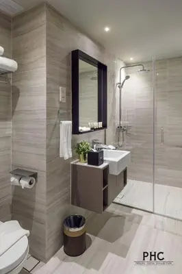 a bathroom with a sink and a shower and a toilet at Hutton Suite Hotel Managed by The Ascott Limited in George Town