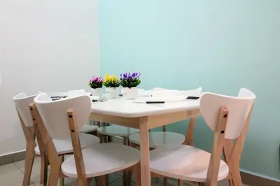 a dining room table with chairs and flowers on it at H2H - Nichole Maison - Majestic Ipoh in Ipoh