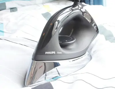 a black computer mouse sitting on top of a bed at H2H - Nichole Maison - Majestic Ipoh in Ipoh