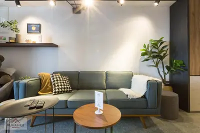 a living room with a blue couch and a table at RumahKu Georgetown in George Town