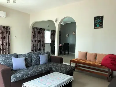 a living room with a couch and a table at D’House in Ipoh