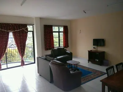 a living room with a couch and a table at Bzout rents in Cameron Highlands