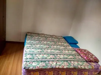 a bedroom with a bed with a colorful bedspread at Bzout rents in Cameron Highlands