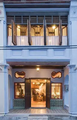 a large white building with an open door at 23 Love Lane Hotel in George Town