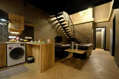 a kitchen with a washer and a living room at 1969 Business Suites Bandar Botani, Ipoh in Ipoh