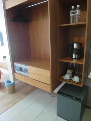 a cupboard with a microwave and a coffee maker at French Hotel in Ipoh