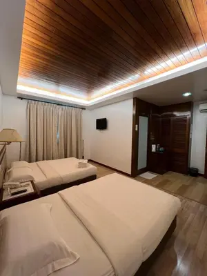 a hotel room with two beds and a window at D Eastern Hotel in Ipoh