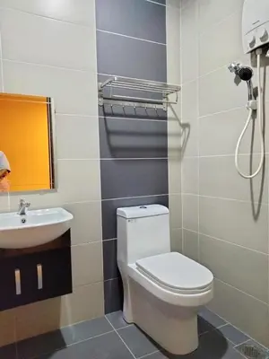 a bathroom with a toilet and a sink at Weng Kong Homestay in Slim River