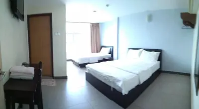 a bedroom with a bed and a desk and a chair at Starview Hotel in Lumut