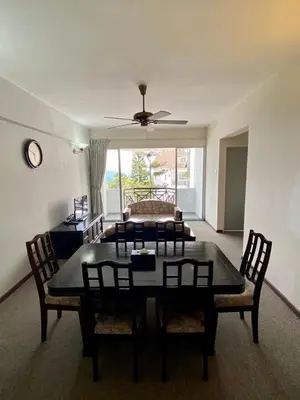 a living room with a table and chairs and a couch at Habitat Fraser's Hill in Bukit Fraser