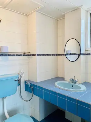 a bathroom with a sink and a toilet and a mirror at Habitat Fraser's Hill in Bukit Fraser