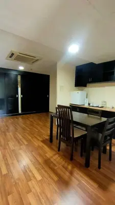 a dining room with a table and chairs on a wooden floor at The Jerai Hotel Sungai Petani in Sungai Petani