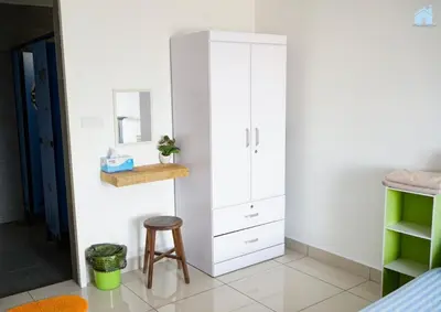 a white cabinet in a room with a stool at HomeSweetHome in Perai